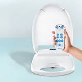 Omigo CMAO Luxury Bidet Seat with lid open and hand holding the remote control  against blue background