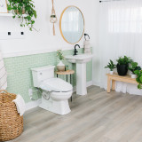 OmigoGS Essential Bidet Toilet Seat installed in a white bathroom with mint accent wall