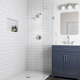Brondell Nebia Yuba 5-Setting Fixed Showerhead chrome installed modern bathroom with a blue vanity.