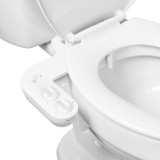 Close-up of white toilet with Brondell PureSpa Advanced Warm Water Bidet Attachment, featuring dual control knobs on the left side for pressure and temperature.