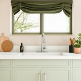 Brondell Jema Touchless Pull-Down Kitchen Faucet in SpotClear Stainless Steel featured in a bright, modern kitchen with green cabinetry, a large window, and clean, minimalist décor for a fresh, airy look.