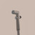 Brondell CleanSpa hand-held bidet sprayer in front of a brown background