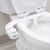 Omigo Element plus bidet attachment installed on standard toilet with seat up