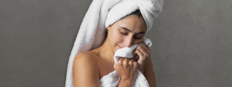 woman wrapped in Brondell nebia bath towel around her body & head.