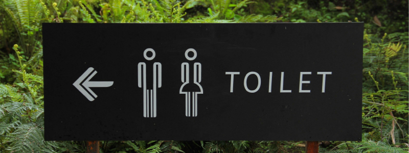 sign pointing to toilets.