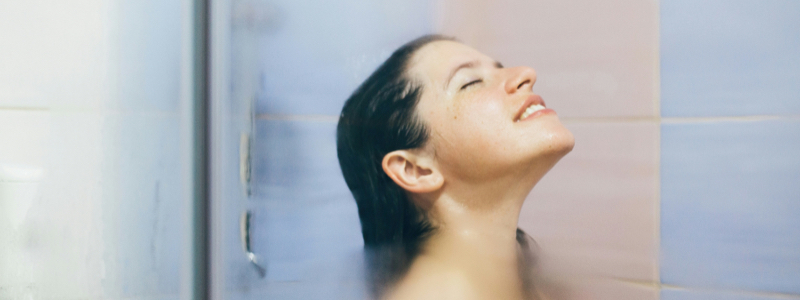 Closeup view of woman's head enjoying a shower.