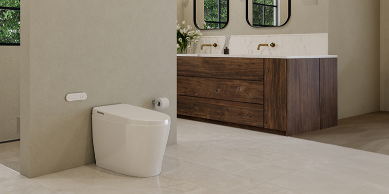 Modern bathroom with white toilet, dual-sink wooden vanity with gold faucets, black-framed mirrors, beige tile floor, and green plants visible through glass panels.