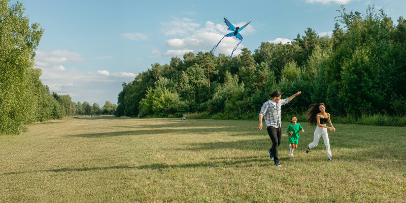 Couple flying a kite with their child.