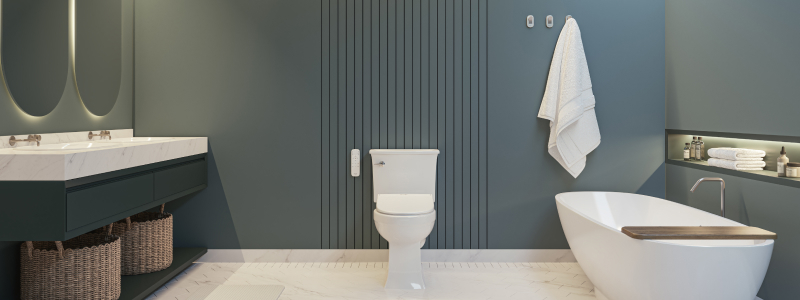 Modern bathroom with a toilet fitted with a Swash Eco Thinline T66 Luxury Bidet Toilet Seat with Remote Control, featuring a sleek vanity with dual mirrors, woven storage baskets, a freestanding bathtub, and neatly arranged towels against a soft blue wall.