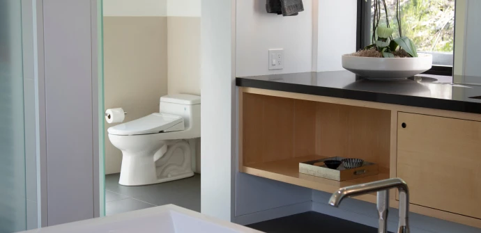 Swash T44 Luxury Bidet Toilet Seat with Remote Control installed on a white toilet in a modern bathroom, showcasing its slim design and seamless fit.