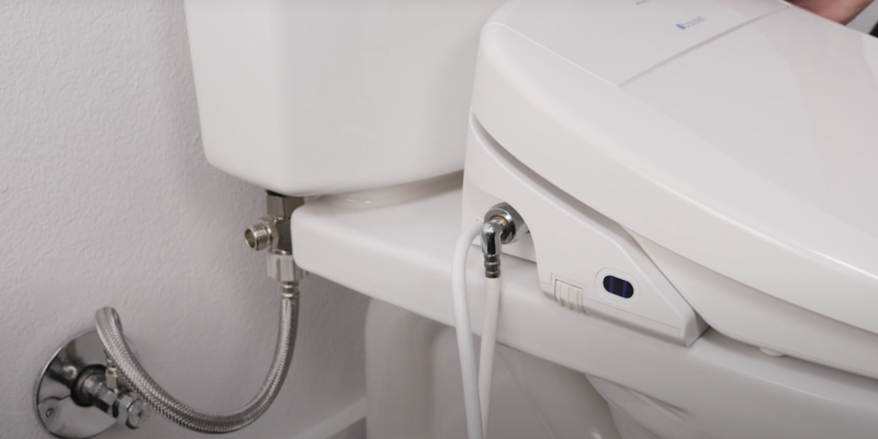 side view installed bidet toilet seat showing plumbing connections