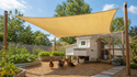 Euchirus sand shade sail over backyard chicken coop and garden