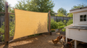 Euchirus sand shade sail installed vertically beside chicken coop for side sun shade