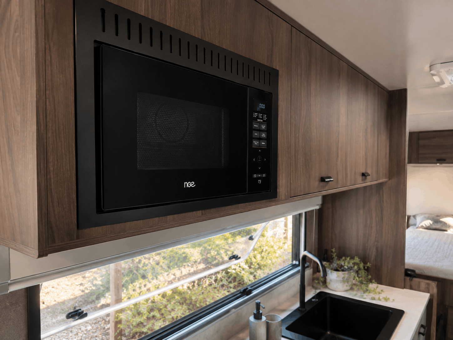 NCE 29L 4-in-1 Convection Microwave Oven installed in a modern caravan kitchen