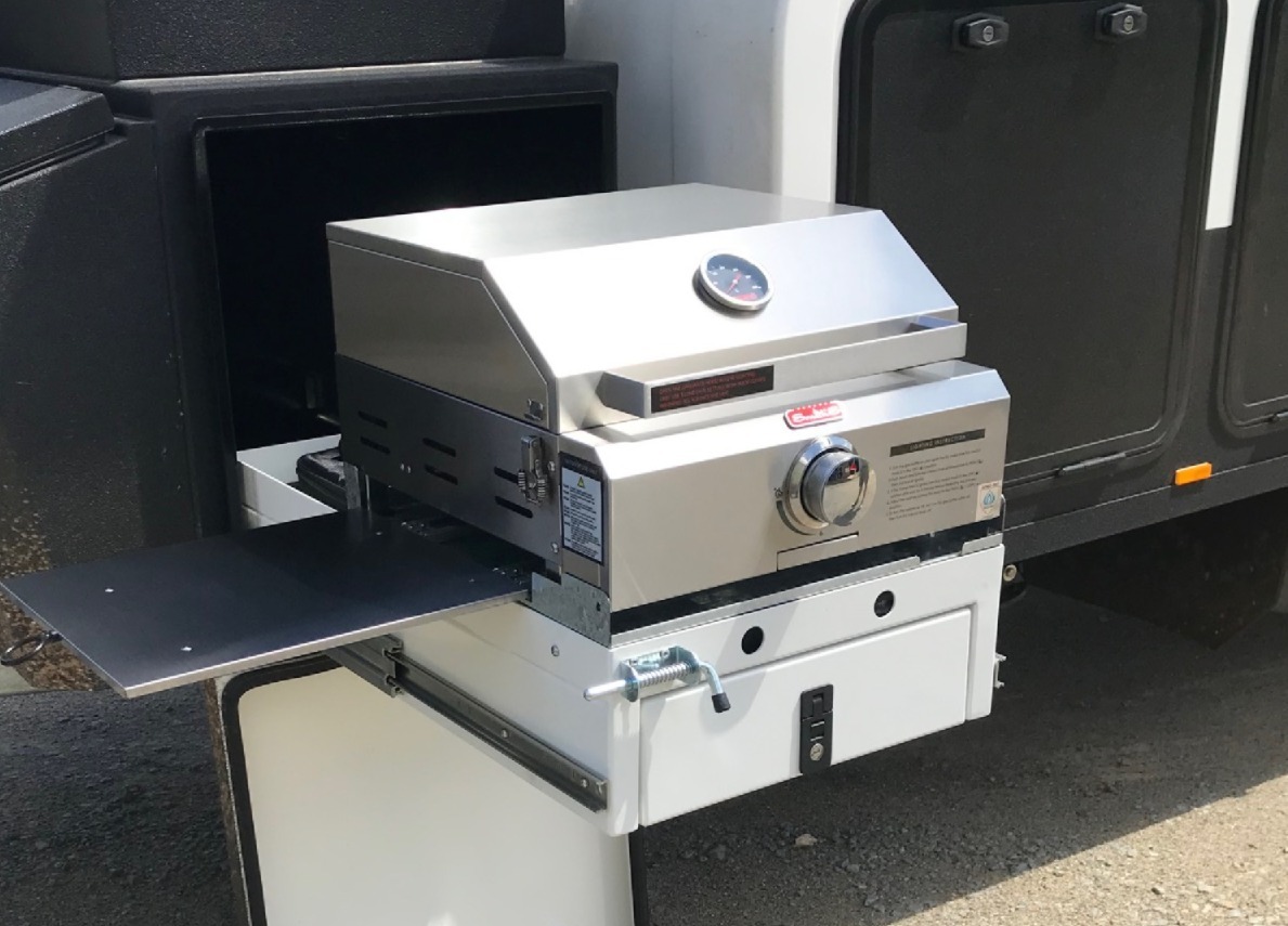 Portable caravan BBQ cooking setup outdoors