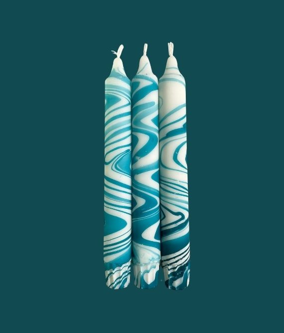 Close-up of Tranquil Tides candle: The intricate swirls of turquoise and teal create a mesmerising visual display, inviting tranquility and calmness.