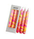 Neon hand marbled candle in pink, orange, and yellow, packaged in a pretty foiled white gift box