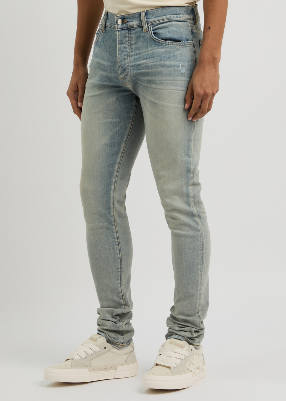 AMIRI Stack distressed slim-leg jeans | Harvey Nichols