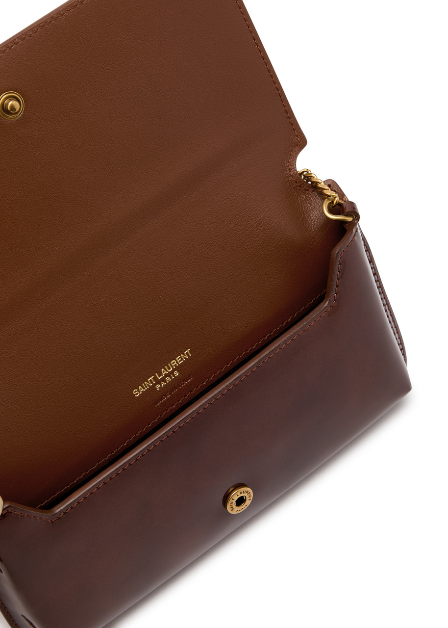 SAINT LAURENT Cassandre patent leather phone case | Harvey Nichols