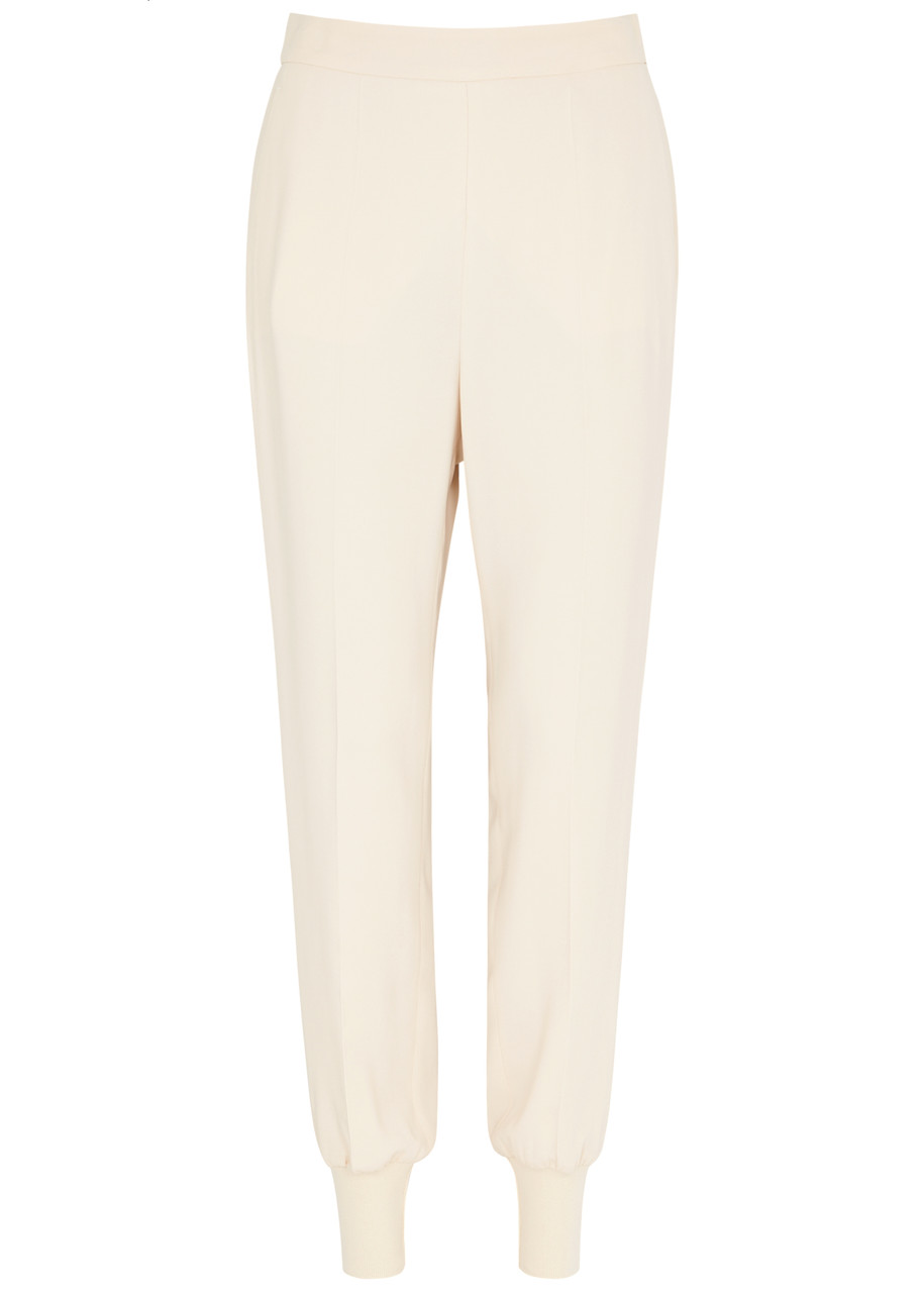 Shop Stella Mccartney Iconic Tapered Stretch-jersey Trousers In Off White