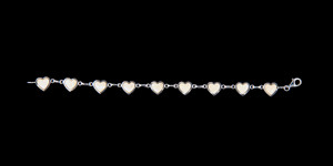 This trendy round mammoth ivory is inlayed into a beautiful heat shaped sterling silver bracelet.  The dimension of the bracelet is approximately 7" x .4".