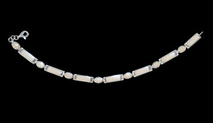 This trendy round mammoth ivory is inlayed into an elegant alternating rectangle and oval shaped sterling silver bracelet.  The dimension of the bracelet is approximately 7" x .21".