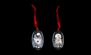 Wolf Face This is a beautiful double sided ornament with a wolf theme.  This is part of the incredible line of Mossup Valley Designs that we carry, with the wonderful artist Rachel Badeau.  The dimensions of the ornament are  3.28" x 1.61".  The SKU is MVD ORN 11.