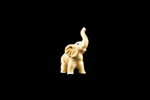 This is a exquisite hand carved eco-ivory Mini Elephant Statue.  The dimensions of the Mini Elephant Statue are 0.52" x 1.22" x 0.93".  The SKU is C-60.

This unique Mini Elephant Statue will make a great addition to any room in the house.  You can place it on any flat surface to display, or a great gift for children to have.