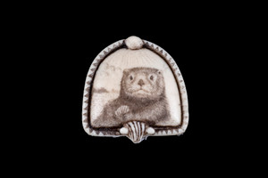 This is a beautiful originally hand etched Sea Otter designed pin/pendant. The backing of this piece has the findings to be a pin, as well as a pendant.  They come with an 18" Silver Plated Chain.  This is part of the incredible line of Mossup Valley Designs that we carry, with the wonderful artist Rachel Badeau.  The dimensions of the necklace are 1.35" x 1.39" x 0.28".  The SKU is MVD PN 10.

Rachel Badeau has been etching and engraving in a variety of media for over thirty years.  Her work, characterized by fine line and intricate detail, attempts to touch the hearts and emotions of others.  All while reflecting her love of animals, nature and the human spirit.  

The resin scrimshaw piece is originally hand etched by Rachel Badeau.  We make a mold of the original piece and do an open cast pour of our resin mixture.  The pieces are removed from the mold and sanded and inked.