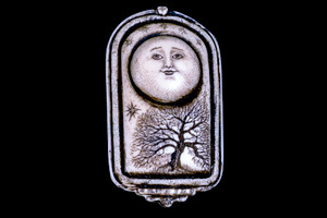 MVD PN 07 Moon and Tree of Life Zoom.  This unique originally hand etched MoonTree designed pin/pendant. The backing of this piece has the findings to be a pin, as well as a pendant.  They come with an 18" Silver Plated Chain.  This is part of the incredible line of Mossup Valley Designs that we carry, with the wonderful artist Rachel Badeau.  The dimensions of the necklace are 1.27" x 2.21" x 0.51".  The SKU is MVD PN 7

Rachel Badeau has been etching and engraving in a variety of media for over thirty years.  Her work, characterized by fine line and intricate detail, attempts to touch the hearts and emotions of others.  All while reflecting her love of animals, nature and the human spirit.  

The resin scrimshaw piece is originally hand etched by Rachel Badeau.  We make a mold of the original piece and do an open cast pour of our resin mixture.  The pieces are removed from the mold and sanded and inked.