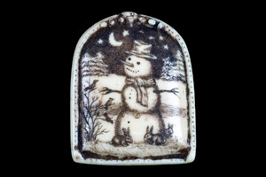 MVD PN 37 Winter Night Zoom.  This distinct originally hand etched Winter Night designed pin/pendant. The Winter Night design is that of a Snowman.  The backing of this piece has the findings to be a pin, as well as a pendant.  They come with an 18" Silver Plated Chain.  This is part of the incredible line of Mossup Valley Designs that we carry, with the wonderful artist Rachel Badeau.  The dimensions of the necklace are 1.17" x 1.44" x 0.37".  The SKU is MVD PN 37.

Rachel Badeau has been etching and engraving in a variety of media for over thirty years.  Her work, characterized by fine line and intricate detail, attempts to touch the hearts and emotions of others.  All while reflecting her love of animals, nature and the human spirit.  

The resin scrimshaw piece is originally hand etched by Rachel Badeau.  We make a mold of the original piece and do an open cast pour of our resin mixture.  The pieces are removed from the mold and sanded and inked.