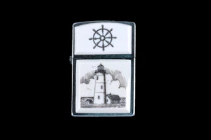 This is a stunning Nautical originally hand etched Eco-Ivory Scrimshaw Lighthouse designed Zippo Lighter! The top of the flip lighter has a a Ship Wheel piece.  The Zippo is a Brushed Chrome finish. Each lighter has a bottom stamp signifying the year it was made, is refillable. All windproof lighters are American made in Bradford, PA factory and come packaged in a gift box.  This is part of the Save the Elephant Collection and was originally hand etched by Linda Layden. The SKU is NC 54 - 223.

The Zippo Lighter is 2.24" x 1.51" x 0.59".  It weighs 2.04 oz.