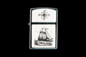 This is a incredible Nautical Style Eco-Ivory Scrimshaw Schooner Ship designed Zippo Lighter! The top of the flip lighter has a Compass Rose design.  The Zippo is a Brushed Chrome finish. Each lighter has a bottom stamp signifying the year it was made, is refillable. All windproof lighters are American made in Bradford, PA factory and come packaged in a gift box.  This is part of the Save the Elephant Collection and was originally hand etched by Bill Feeney. The SKU is NC 54 - 450.

The Zippo Lighter is 2.24" x 1.51" x 0.59".  It weighs 2.04 oz.
