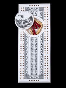 This wonderful two person and our two team cribbage boards is a beautiful accent piece for your home or take it on the road for use as a travel cribbage board.  With the magnet holding the center piece and pegs in place it is a stunning travel cribbage board. 

This is a beautiful originally hand etched Golfer Eco - Ivory Scrimshaw Cribbage Board!   The center circular piece has a magnet holding it in place.  Pushing on the base of the piece pops the Large round off the board, where the pegs are stored.  All cribbage boards come with 3 red and 3 white/yellow wooden pegs. 

The cribbage board itself is made for two players or teams.  The board has a native geometric design that was originally hand etched.  The large round piece has a magnet on the back to keep it secured to the board and store the pegs.  The pegs are made of wood.  This is part of the Save the Elephant Collection and was originally hand etched by Linda Layden.  The SKU is NC 53 - 152.

The Cribbage Board is 8.50" x 3.46" x 0.46".  It weighs 11.28 oz.