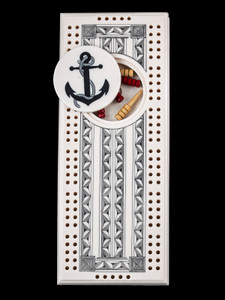 This wonderful two person and our two team cribbage boards is a beautiful accent piece for your home or take it on the road for use as a travel cribbage board.  With the magnet holding the center piece and pegs in place it is a stunning travel cribbage board. 

This is a unique originally hand etched Anchor Design Eco - Ivory Scrimshaw Cribbage Board!  The center circular piece has a magnet holding it in place.  Pushing on the base of the piece pops the Large round off the board, where the pegs are stored.  All cribbage boards come with 3 red and 3 white/yellow wooden pegs. 

The cribbage board itself is made for two players or teams.  The board has a native geometric design that was originally hand etched.  The large round piece has a magnet on the back to keep it secured to the board and store the pegs.  The pegs are made of wood.  This is part of the Save the Elephant Collection and was originally hand etched by Linda Layden.  The SKU is NC 53 - 416A.