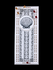 This wonderful two person and our two team cribbage boards is a beautiful accent piece for your home or take it on the road for use as a travel cribbage board.  With the magnet holding the center piece and pegs in place it is a stunning travel cribbage board. 

This is a beautiful originally hand etched Seashell Design Eco - Ivory Scrimshaw Cribbage Board!  The center circular piece has a magnet holding it in place.  Pushing on the base of the piece pops the Large round off the board, where the pegs are stored.  All cribbage boards come with 3 red and 3 white/yellow wooden pegs. 

The cribbage board itself is made for two players or teams.  The board has a native geometric design that was originally hand etched.  The large round piece has a magnet on the back to keep it secured to the board and store the pegs.  The pegs are made of wood.  This is part of the Save the Elephant Collection and was originally hand etched by Linda Layden.  The SKU is NC 53 - 416SS.

The Cribbage Board is 8.50" x 3.46" x 0.46".  It weighs 11.28 oz.