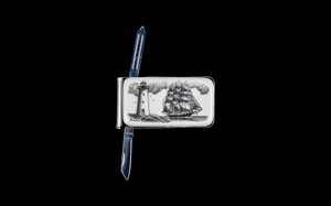 NC 20 Ship and Lighthouse Knife Open.  This beautiful originally hand etched Ship and Lighthouse design on a Large Rectangle Knife Money Clip.  This unique money clip has a small knife blade and a nail filer.  This is a useful money clip that duals as a practical knife.

The artwork was originally hand etched by Linda Layden.  The dimensions of the Large Rectangle Knife Money Clip with the blade(s) closed are 2.08" x 1.32" x 0.30".  The knife blade itself is approximately 1.45" and the nail file is approximately 1.50", making the width of the money clip with both open 5.03".  The SKU is NC 20 - 406.

Linda Layden has been making beautiful works of art in the scrimshaw field for over 40 years.  Originally a hobby that became a full time job.  Her work can be found in gift shops, galleries and museums across the world.  

The resin scrimshaw piece is originally hand etched by Linda Layden.  We make a mold of the original piece and do an open cast pour of our resin mixture.  The pieces are removed from the mold and sanded and inked.

We believe that serving nature is one of the commissions that we as humans have been given here on earth.  We wish to lend our resources to those charged with protecting elephants from poaching for their ivory. 

On a monthly basis we donate to organizations whose purpose to protect the elephants and other species throughout the planet.  We focus our donations on organizations that put the money to good use and have a low overhead. With the majority of incoming funds going back to saving the elephants!

Features
Hand Etched Acrylic Resin Scrimshaw 
Originally Hand Etched in the USA! 
NC 20 Large Rectangle Money Clip Knife
Stainless Steel 
Small Knife Blade
Small Nail Filer
Nautical Design
Ship and Lighthouse
Save the Elephant Collection