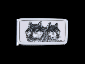 This stunning originally hand etched Double Wolf design on a Large Slide Rectangle Money Clip.  This unique piece is a slide money clip.

The artwork was originally hand etched by Linda Layden.  The dimensions of the Large Rectangle Money Clip is 2.08" x 1.32" x 0.30".  The SKU is NC 22 - 105A.

Linda Layden has been making beautiful works of art in the scrimshaw field for over 40 years.  Originally a hobby that became a full time job.  Her work can be found in gift shops, galleries and museums across the world.  

The resin scrimshaw piece is originally hand etched by Linda Layden.  We make a mold of the original piece and do an open cast pour of our resin mixture.  The pieces are removed from the mold and sanded and inked.

We believe that serving nature is one of the commissions that we as humans have been given here on earth.  We wish to lend our resources to those charged with protecting elephants from poaching for their ivory. 

On a monthly basis we donate to organizations whose purpose to protect the elephants and other species throughout the planet.  We focus our donations on organizations that put the money to good use and have a low overhead. With the majority of incoming funds going back to saving the elephants!

Features
Hand Etched Acrylic Resin Scrimshaw 
Originally Hand Etched in the USA! 
NC 20 Large Rectangle Money Clip Knife
Stainless Steel 
Animal Design
Double Wolf Face
Save the Elephant Collection