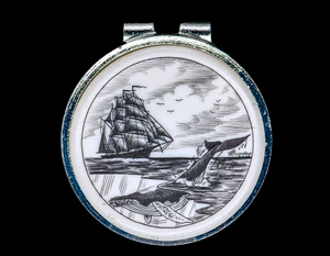 Ship and Whale Money Clip.  This beautiful originally hand Scrimshaw Ship and Whale design on a Rond Spring Money Clip.  This unique piece is a spring money clip.  The back of the money clip has a stainless steel spring that will hold your money secure.  Regardless if it is a small or large stack of bills.  

The artwork was originally hand etched by Linda Layden.  The artistic insert is an 1.5", the size of a silver dollar.  The dimensions of the Large Rectangle Money Clip is 1.68" x 1.81" x 0.46".  The SKU is NC 24 - 403.