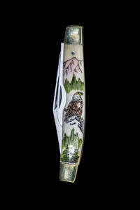 Eagle Dual Blade Knife.  This stunning hand etched Eagle design on a 440 Stainless Steel Dual Blade Knife.  The Eagle is perched on a tree with mountains in the background.  The knife design is similar to the Shrade 33 knife.  This beautiful knife is part of the Scrimshaw Collection, with those words laser engraved into the blade.  The DB 33 knifes come with the pictured leather sheath and each scale is made with Bovine Bone.  The DB 33 Knife has bolsters that are nickel silver with brass pins and liner.  It is a dual blade knife and a very useful pocket knife.  The dimensions of the DB 33 Pocket Knife with the blade closed are 3.28" x 0.69" x 0.50".  The large blade itself is approximately 2.45" making the width of the knife with an open blades 5.73".  The small blades length is approximately 1.77".  The SKU is DB 33 - 133VC.
