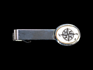 Compass Rose Tie Bar NC 87B - 149.  This stunning hand etched Compass Rose design looks beautiful on the tie bar. The Tie Bar is made of solid brass and made in the USA.  It has a Rhodium finish that gives it the unique silver look.  It is a very durable finish.  This unique Compass Rose Tie Bar weighs 3.5 ounces.  The dimensions are 2.08" x .66"x .65".    The item number is NC 87B - 149.