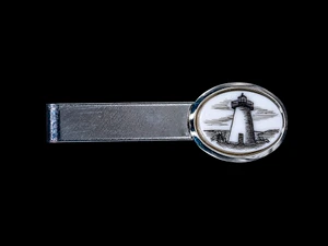 Ned's Point Lighthouse Tie Bar NC 87B-820.  This beautiful hand etched Lighthouse design looks wonderful on the tie bar. The Tie Bar is made of solid brass and made in the USA.  It has a Rhodium finish that gives it the unique silver look.  It is a very durable finish.  This unique Lighthouse Tie Bar weighs 3.5 ounces.  The dimensions are 2.08" x .66"x .65".    The item number is NC 87B - 820

Ned's Point Lighthouse is a historic lighthouse on Ned's Point Road in Mattapoisett, Massachusetts. The lighthouse was built in 1838 and was named after Ned Dexter, a local farmer. Ned's Point was constructed with a birdcage-style lantern. The stone used for the lighthouse was all locally sourced, with most of it originating from nearby beaches. Inside the lighthouse, there are 32 granite steps that are cantilevered to the outside wall without the use of mortar. The original lantern used 11 whale oil lamps, each with its own parabolic reflector.