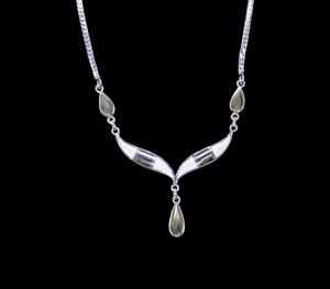 Whale Tail with Teardrop Mammoth Jade Sterling Silver Pendant 

This unique whale tail with Teardrop Alaskan Mammoth Jade shaped whale tail is inlayed into a Sterling Silver pendant.  This pendant comes with an 18" Sterling Silver chain.  The dimensions of the Alaskan Jade pendant is approximately 2.25" x 1.7".  The product id # is PMJ-1008-S

The pre-historic Mammoth tusks are found as a bi - product of the gold mining industry in Alaska. They are carbon dated to be approximately 25,800 years old.  The color of your mammoth tusk may vary due to the minerals in the ground water where the tusks are buried.  The varying color of the mammoth tusks make each piece of jewelry unique. Cracks and splits in the ivory occur naturally due to it’s great age.  Our materials are considered eco-friendly because no animals were harmed in the making of this beautiful piece of jewelry. 

Genuine Jade (nephrite) is a fascinating gemstone and the state gem of Alaska. In prehistoric times, prized for its toughness, jade was used to make weapons, tools and later simple ornaments. Jade purportedly can protect you from evil, attract love and of course bring you good luck. It is now regarded as a symbol of energy and beauty. Stimulating creativity and mental agility along with harmony and balance. The jade we use comes from the Nana Region of Alaska.