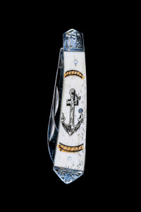 DB 2222 602VC Anchor Design.  This beautiful hand etched Vertical Colored Anchor scene on a 440 Stainless Steel Dual Blade Knife.  The knife design is similar to the Shrade 2222 knife.  This beautiful knife is part of the Scrimshaw Collection, with those words laser engraved into the blade.  The DB 2222 knifes come with the pictured leather sheath and each scale is made with Bovine Bone.  The DB 2222 knife has bolsters that are nickel silver with brass pins and liner.  It is a dual blade knife and a very useful pocket knife.  The dimensions of the DB 2222 Pocket Knife with the blade closed are 3.48" x 0.90" x 0.58".  The large blade itself is approximately 2.67" making the width of the knife with an open blades 6.15".  The small blades length is approximately 1.90".  The SKU is DB 2222 - 602VC.

The scrimshaw is inked with colored india ink and sealed with renaissance wax, which is used by museums for antique restoration.  It also helps bring out the beauty of the artwork as well as in the cow bone. The knife is water resistant, but not waterproof.