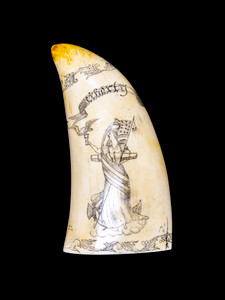SP 06 Front.  This georgous replica Sperm Whale Tooth is part of the collection at the Nantucket Whaling Museum.  The title of this tooth is called "Liberty". It is a replica of an Antique Tooth that was originally made by Artek for the Nantucket Whaling Museum.  The front of the replica tooth depicts Lady Liberty with the phrase "Liberty" is engraved in the tooth.  On the back is battle scence from sea.  The words "Peacock & Le. Epervere" is engraved on the piece.  

The original was etched over 100 years ago.  The reproduced tooth is currently made in our studio in Fall River, MA.  The finish is made to recreate the look of an antique tooth.  

This beautiful replica Sperm Whale Tooth weighs 12.45 ounces.  The dimensions are 3.12" x 6.51" x 2.06".  The item number is SP - 06.