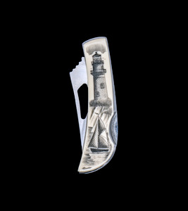 This beautiful originally hand etched Ship and Lighthouse design on a Stainless Steel Silver Hawk Knife.  The back of the knife has a belt clip and all the knifes come with the pictured sheath.  It is a lock blade knife and a useful pocket knife. The artwork was originally hand etched by Linda Layden.  The dimensions of the Silver Hawk knife with the blade closed are 3.00" x 0.96" x 0.55".  The blade itself is approximately 2.35" making the width of the knife with an open blade 5.35".  The SKU is NC 14 - 457.

The Lighthouse depicted is that of Gay Head Lighthouse in Martha's Vineyard, MA.  Gay Head Light is a historic lighthouse located on Martha's Vineyard westernmost point off of Lighthouse Road in Aquinnah, Massachusetts.

Linda Layden has been making beautiful works of art in the scrimshaw field for over 40 years.  Originally a hobby that became a full time job.  Her work can be found in gift shops, galleries and museums across the world.