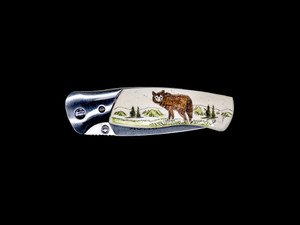 This stunning hand etched Colored Wolf design on a Buck 835 Folding Selkirk Pocket Knife with a bovine bone front handle.  The back of the knife has a belt clip/ money clip.  It is a lock blade knife and a useful pocket knife.  The artwork was originally hand etched by Chris Tyson.  The knife is a liner lock blade, meaning it was made for one handed opening.  The dimensions of the Buck 835 Folding Selkirk Pocket Knife with the blade closed are 4.29" x 1.23" x 0.60".  The blade itself is approximately 3.25" making the width of the knife with an open blade 7.5".  The SKU is NC 835 - 105C.

The stunning design that was hand etched is of a Wolf!

The artwork was originally hand etched by Chris Tyson. A very versatile artist from New England!

The scrimshaw is inked with a colored india ink and sealed with renaissance wax, which is used by museums for antique restoration.  It also helps bring out the beauty of the artwork as well as in the cow bone. The knife is water resistant, but not waterproof.
