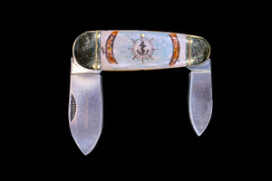 This unique hand etched Nautical Design with an Anchor etched inside of a Ship Wheel that in surrounded by Nautical Rope in a Colored design on bovine bone scales with a 440 Stainless Steel Dual Blade Knife.  The Bovine Bone scale comes from beef bone.  This beautiful knife is part of the Scrimshaw Collection, with those words laser engraved into the blade.  The LB 52 knifes is made with Bovine Bone.  The LB 52 knife has bolsters and the liner that are nickel .  It is a dual blade knife and a very useful pocket knife.  The dimensions of the LB 52 Pocket Knife with the blade closed are 3.98" x 1.36" x 0.47".  The large blade itself is approximately 2.34".  The small blades length is approximately 2.04".  The SKU is LB 52 - 602C

The scrimshaw is inked with colored india ink and sealed with renaissance wax, which is used by museums for antique restoration.  It also helps bring out the beauty of the artwork as well as in the cow bone. The knife is water resistant, but not waterproof.

The back of the knife is a blank Bovine bone.  Personal messages can be added.  It is $15 for one additional line.  This can be selected in the personalized settings.  

The artwork was originally hand etched by Chris Tyson. A very versatile artist from New England!

Each knife is hand etched, and there will be some minor differences between each knife.  

Features
Hand Etched Bovine Bone Knife
Cow Bone
Originally Hand Etched in the USA! 
LB 52

440 Stainless Steel Blade
Bovine Bone Scales
Nickel Silver Bolster 
Dual Blade
Nautical Design
Anchor
Ship Wheel

Nautical Rope
Hand Painted Design
Scrimshaw Collection