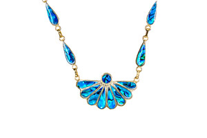 Fan Shape Northern Lights 22K Gold Plate Pendant | F&F Inc.

This impressive Fan Shape Northern Lights piece is inlayed into a 22K Gold Plate pendant.  This pendant comes with an 18" 22K Gold Plate Link Chain.  The dimensions of the Northern Lights pendant is approximately 1.41" x .86" for the main pendant. The teardrop side pieces are .23" by .63". The product id # is PNL-1011-G.

It is a 22K plate on sterling silver. The plating is with 30mils of 14k gold. Typically plating is done with 3mils of gold. We work with the extra gold plating to ensure your beautiful jewelry piece will have a strong gold color for years to come!!  

This is our line of PĀUA Shell Jewelry.  In New Zealand, abalone is called pāua or blackfoot pāua is the ubiquitous New Zealand pāua the highly polished nacre of which is extremely popular as souvenirs with its striking blue, green, and purple iridescence that allows for the stunning jewelry.

Enjoy your unique piece of jewelry!