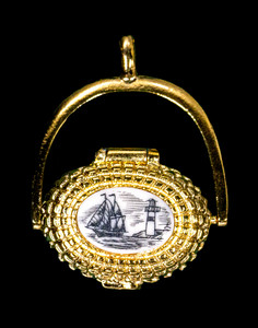 This is an beautifully detailed 22K Plated Gold Nantucket Basket Pendant with a replica scrimshaw with a Ship and Lighthouse design top.  Inside the basket is a mini penny.  The basket on it's own has the following dimensions, .78"x .48"x .77".  The pendant holder add .22" x .85".  Each pendant weighs .31 ounces.  All the pendants come with an 18" gold chain. The item number is GNB 406.

This Nantucket Lightship basket pendant is made in pewter and was plated in 22k Gold.  These beautiful baskets are similar to what is seen on the Netflix hit, Sirens

Nantucket lightship baskets, characterized by their rattan staves, cane weavers, and wooden bases, originated on the island's lightships in the mid-1800s. Initially, these baskets were a way for lightship crewmen to pass the time during long deployments and were primarily utilitarian. Over time, the baskets evolved, becoming more refined and sought after as souvenirs of Nantucket.

Keeping with the tradition of a penny in the basket.  A penny is placed inside the basket to symbolize good luck.  Each of our basket pendants have a mini penny inside to carry on the tradition.  

Linda Layden has been making beautiful works of art in the scrimshaw field for over 40 years.  Originally a hobby that became a full time job.  Her work can be found in gift shops, galleries and museums across the world.  

The resin scrimshaw piece is originally hand etched by Linda Layden.  We make a mold of the original piece and do an open cast pour of our resin mixture.  The pieces are removed from the mold and sanded and inked with Indian Ink.

We believe that serving nature is one of the commissions that we as humans have been given here on earth.  We wish to lend our resources to those charged with protecting elephants from poaching.

On a monthly basis we donate to organizations whose purpose to protect the elephants and other species throughout the planet.  We focus our donations on organizations that put the money to good use and have a low overhead. With the majority of incoming funds going back to saving the elephants!

American Made
Nantucket Basket Pendant
22k Gold Plated
Pewter Base 
Mini Penny
18" Gold Chain
Ship and Lighthouse Design
Resin Scrimshaw Design Top
Lifetime Guarantee